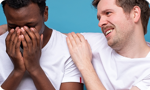 Man placing hand on another man’s shoulder in a caring gesture