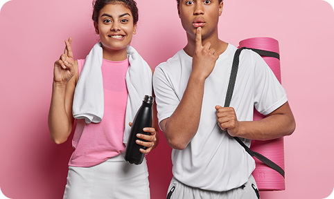 Man and woman in activewear holding a yoga mat and water bottle